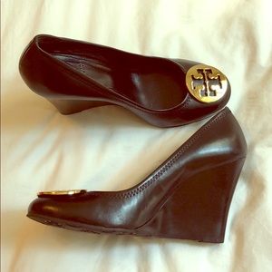 Black Tory Burch wedges with gold logo on toe.